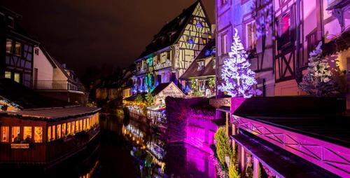 a lit up building with a christmas tree on it at Passage des Romains studio in Horbourg