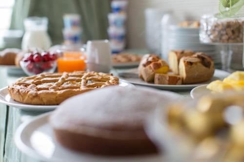 a table topped with plates of pastries and orange juice at Ristorante Hotel Lucia - 100 mt dal mare in Giulianova