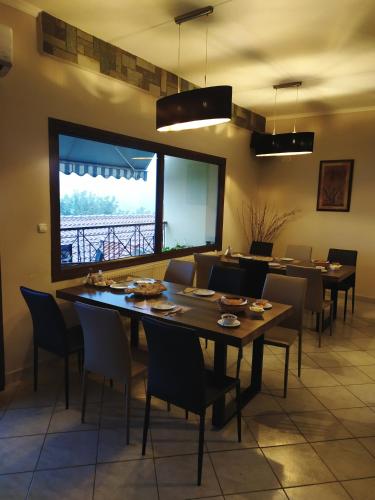 a dining room with a large table and chairs at SmallHotel - Vevi in Vévi