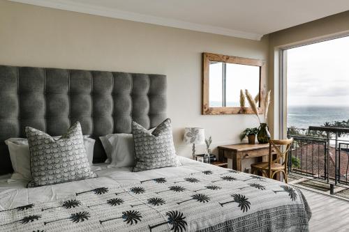 a bedroom with a large bed with a large window at Royal Boutique Hotel in Cape Town