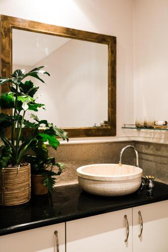 a bathroom with a large mirror and a sink at Royal Boutique Hotel in Cape Town