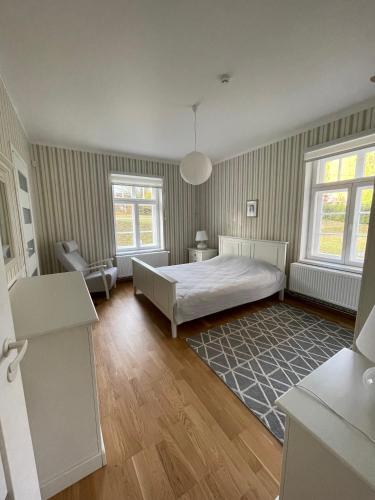 a bedroom with a bed and two windows at Pühajärve residents in Otepää