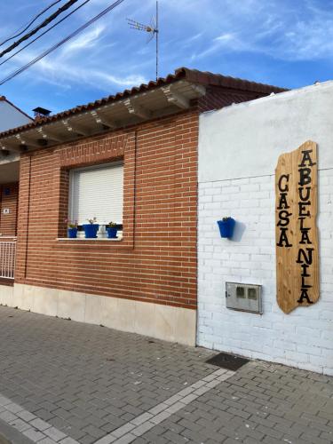 a building with a sign on the side of it at Casa Abuela Nila in Cogeces de Iscar