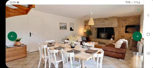 a living room with a table and a couch at La maison du village in Ploemel