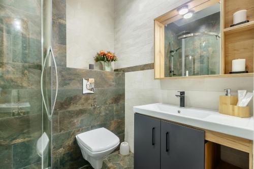 a bathroom with a sink and a toilet at LUX Apartments on Soborniy lane in Rostov on Don