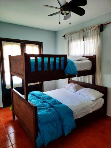 two bunk beds in a room with a ceiling fan at Cabañas San Miguel in Alto Boquete