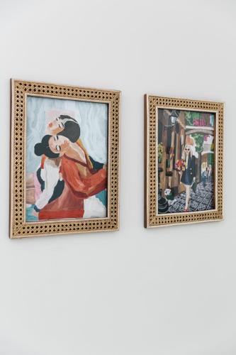two framed paintings of a woman on a wall at Royal Boutique Hotel in Cape Town