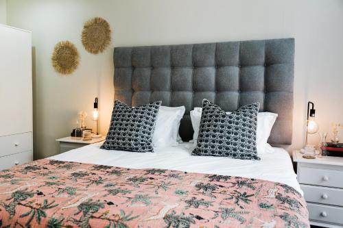 a bedroom with a large bed with a large headboard at Royal Boutique Hotel in Cape Town