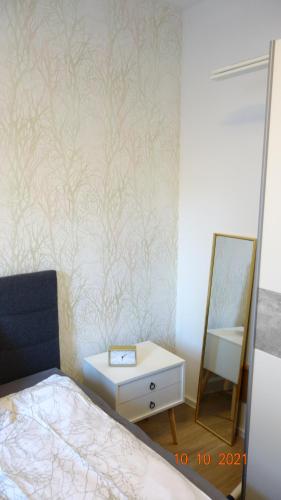 a bedroom with a bed and a dresser and a mirror at Apartment Weberstrasse in Tübingen