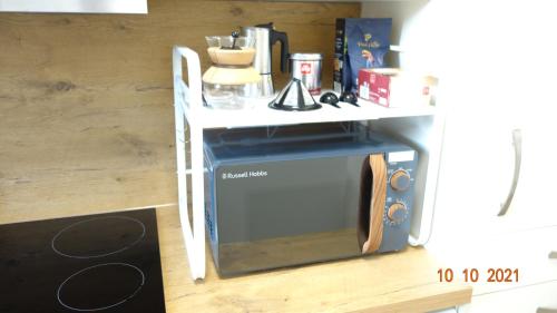 a microwave oven with a table on top of it at Apartment Weberstrasse in Tübingen