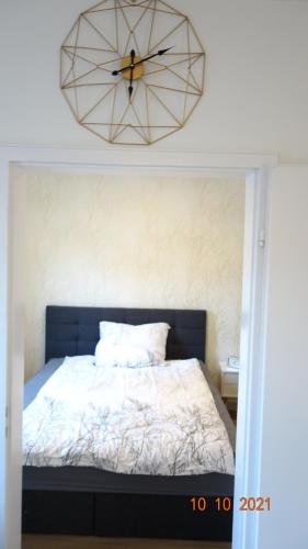 a bedroom with a bed with a large clock on the wall at Apartment Weberstrasse in Tübingen