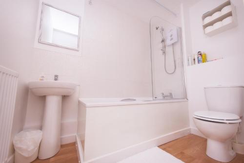 Baño blanco con aseo y lavamanos en Birmingham Apartments Lozells, City Centre en Birmingham