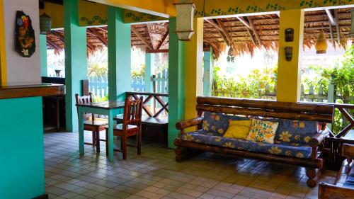 a living room with a couch and a table at Cabinas Guarana in Puerto Viejo