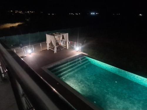 an overhead view of a swimming pool at night at Eva Luxury Villa in Lachi