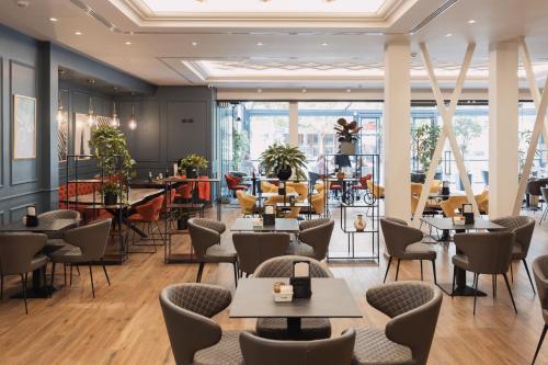a restaurant with tables and chairs and a cafeteria at Hotel Boutique Vila 135 in Tirana