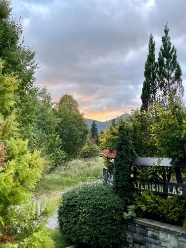 a sign for a garden in the middle of a field at Chalet House Olga in Crni Lug
