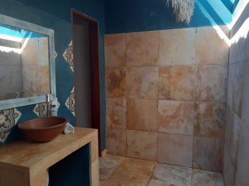 a bathroom with a sink and a wooden bowl at Chalés Bons Ventos - Icaraizinho in Icaraí