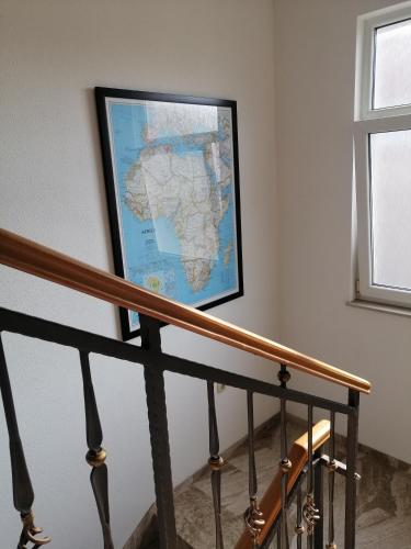 a map hanging on a wall next to a staircase at Apartment Ivan-Experience 3 Bedrooms in Ljubuški
