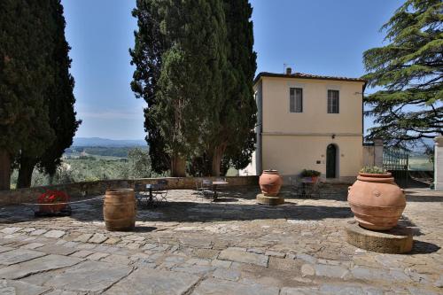 a group of large vases sitting in front of a building at Fattoria di Cinciano in Poggibonsi