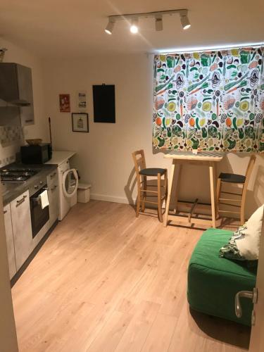 a living room with a kitchen and a table and chairs at Giglio Home in Catania