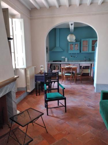 a living room with a table and chairs and a fireplace at IL DECUMANO CHARME APARTMENTS in Arezzo