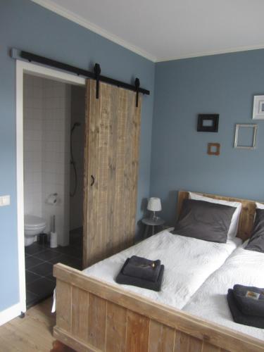 a bedroom with a bed with two towels on it at Oekepoek Down Town in Enschede