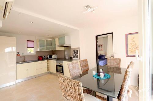 une cuisine avec une table et des chaises dans une pièce dans l'établissement VILLA THETIS 4 pièces, à Antibes