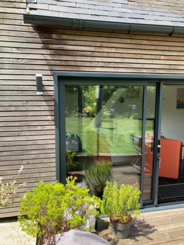 a sliding glass door of a house with plants at TinyHouse LE CONQUET in Le Conquet
