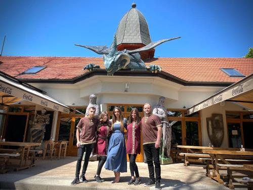 a group of people standing in front of a building at Excalibur miniHotel in Eger