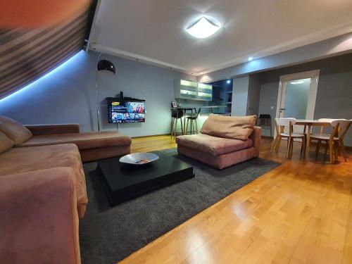 a living room with a couch and a table at Amazing Penthouse old town in Sarajevo