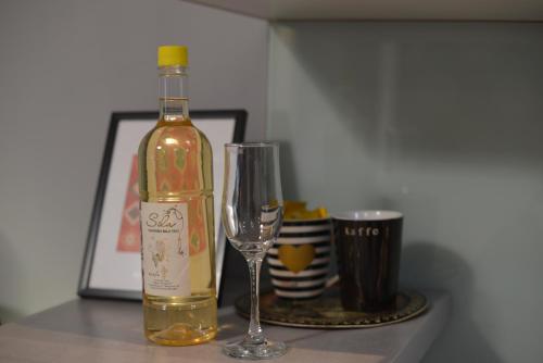 a bottle of wine sitting next to a wine glass at Amazing Penthouse old town in Sarajevo