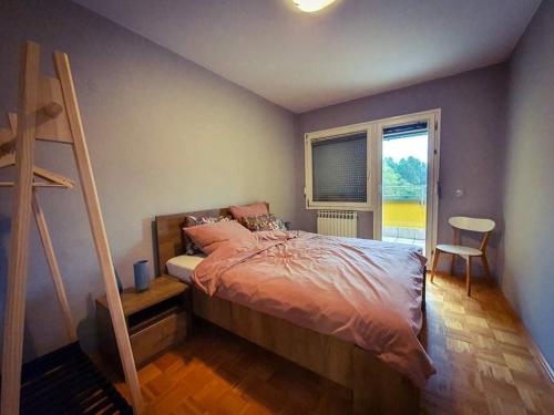 a bedroom with a bed and a ladder and a window at Amazing Penthouse old town in Sarajevo