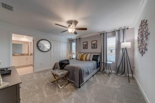 a bedroom with a bed and a ceiling fan at NEWLY LISTED Townhouse Storey Lake, Free Waterpark in Kissimmee
