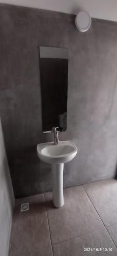 a bathroom with a white sink and a mirror at Arazá in Cuchilla Alta