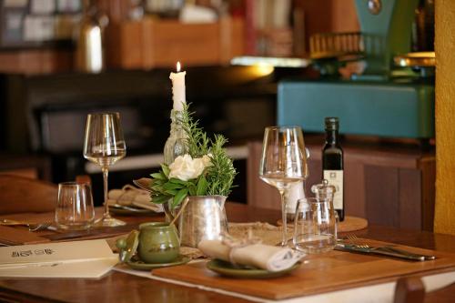 a table with wine glasses and a candle on it at Fattoria di Cinciano in Poggibonsi