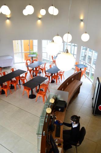 a woman sitting at a table in a restaurant at Hotel Bait in General Roca