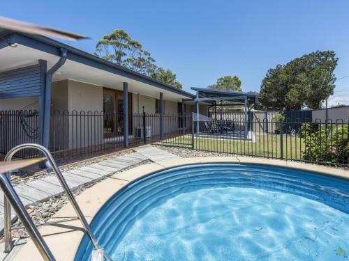 a swimming pool in front of a house at Bundjalung and Baby Bundjalung in Iluka