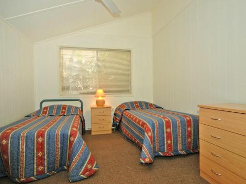 a bedroom with two beds and a window at Bayview at Iluka in Iluka