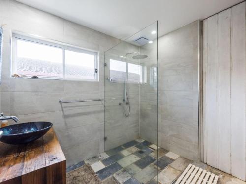 a bathroom with a sink and a glass shower at BellaLuka in Iluka