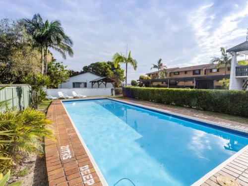 a swimming pool in the backyard of a house at Iluka Villa 1 in Iluka