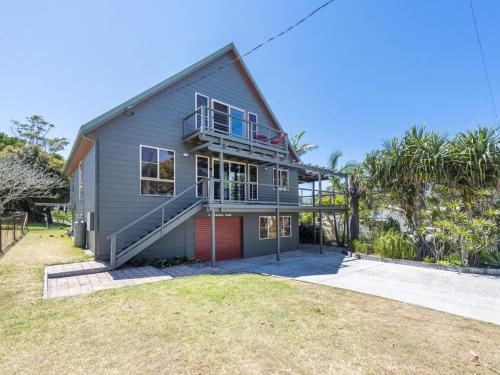 a house with a balcony and a yard at Ilukaholic in Iluka