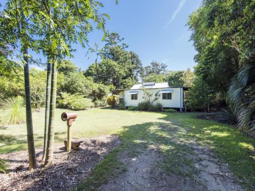 a house in the middle of a yard at Long Haven in Iluka