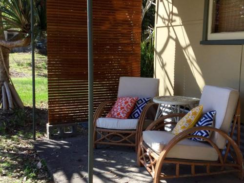 
a living room with a couch and a chair at little beach house in Iluka
