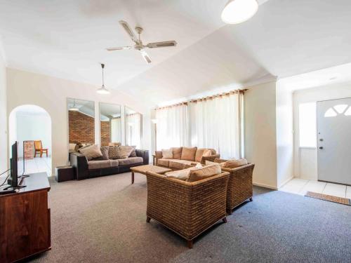 
a living room filled with furniture and a large window at Rainforest Retreat in Iluka
