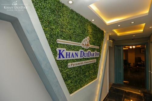 a sign for khan durians on the wall of a building at Khan Duidar Inn - Pyramids View Rooftop in Cairo