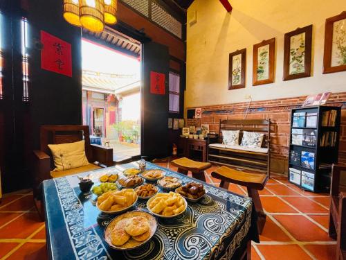 a table with many plates of food on it at Grace Kinmen B&B in Jincheng