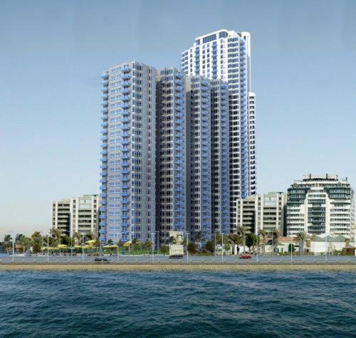 a group of tall buildings in front of the water at شقة فاخرة vip مطلة على البحر برج المسارات in Jeddah
