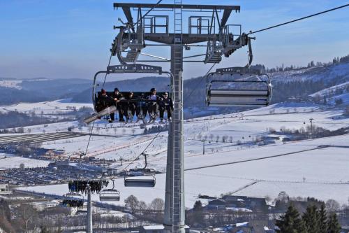 a group of people riding on a ski lift at Appartement Gänseblümchen in Willingen