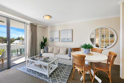 a living room with a couch and a table at The Point Resort in Bargara