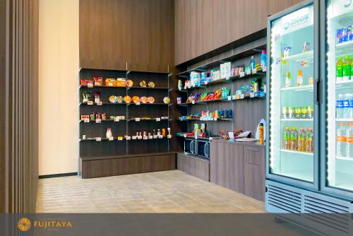 a store with a refrigerator and shelves of food at FUJITAYA Querétaro in Querétaro